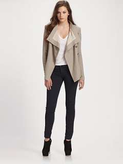 Stand collar Asymmetrical front buttons Long sleeves Welt pockets 